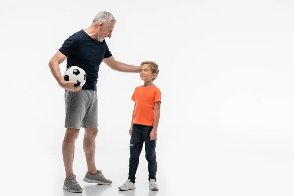 Happy Grandfather Touching Head Smiling Grandson While Holding Soccer Ball — Stock Photo, Image