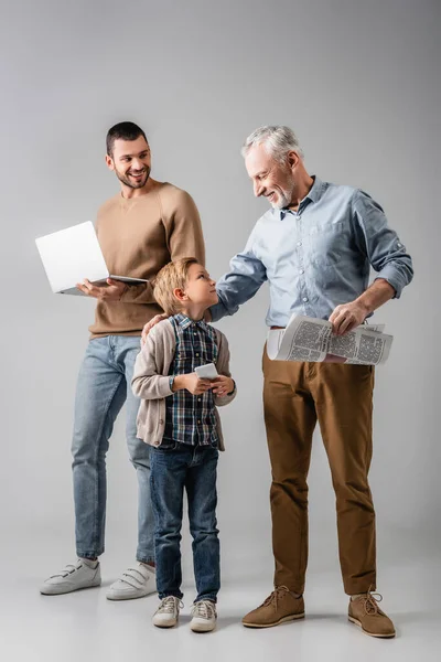 Happy Boy Looking Grandfather Newspaper Dad Holding Laptop Grey — Stock Photo, Image