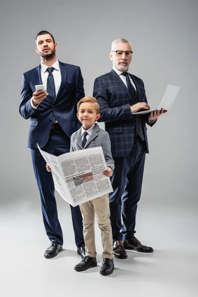 Smiling Boy Newspaper Looking Camera Dad Grandfather Holding Gadgets Grey — Stock Photo, Image
