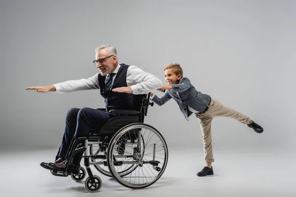 Mature Man Wheelchair Imitating Flight While Having Fun Grandson Grey — Stock Photo, Image