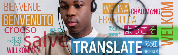 african american interpreter working in headset, translate lettering near words in different languages illustration. Translation: "welcome"