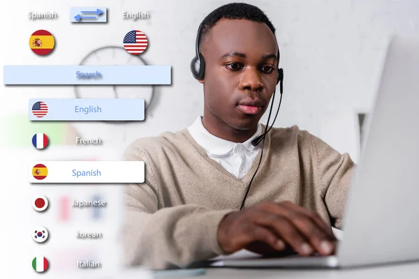 アフリカ系アメリカ人の若い通訳者がノートパソコンをぼやけた前景に入力し翻訳アプリインターフェースのイラストを — ストック写真