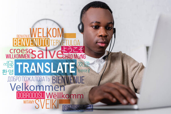 african american interpreter in headset near laptop, translate lettering near words in foreign languages. Translation: "welcome"