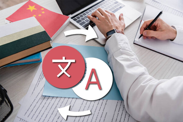 partial view of interpreter typing on laptop and writing in notebook, icons with arrows illustration