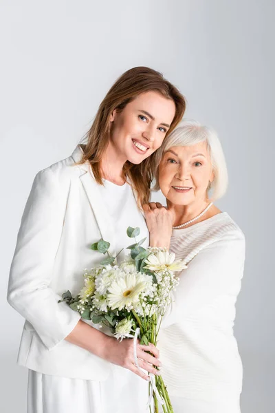 Cheerful Daughter Holding Flowers Smiling Happy Senior Mother Isolated Grey — Stock Photo, Image