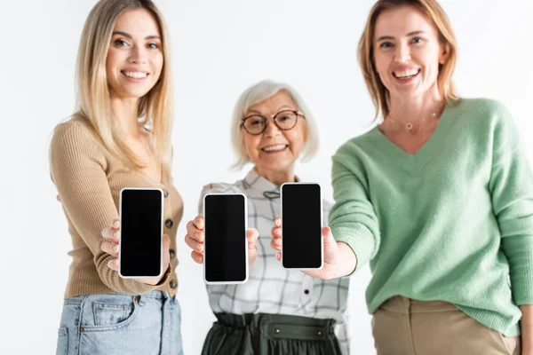 Three Generation Happy Women Holding Smartphones Blank Screen Isolated White — Stock Photo, Image