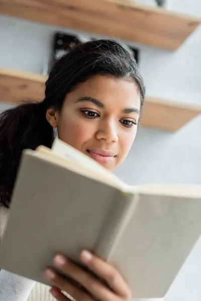 Young African American Woman Reading Book Home Blurred Foreground — Stock Photo, Image