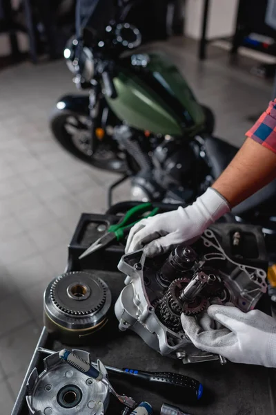 Cropped View Mechanic Disassembled Gearbox Motorbike Blurred Background — Stock Photo, Image