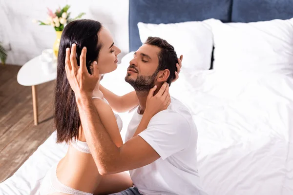 Seductive Girlfriend Lingerie Hugging Smiling Boyfriend Shirt Bed Blurred Background — Stock Photo, Image