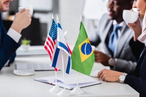 Selective Focus American Brazilian Israeli Flags Interracial Business Partners Drinking — Stock Photo, Image