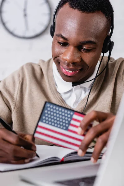 Smiling African American Interpreter Headset Writing Notebook While Holding Digital — Stock Photo, Image