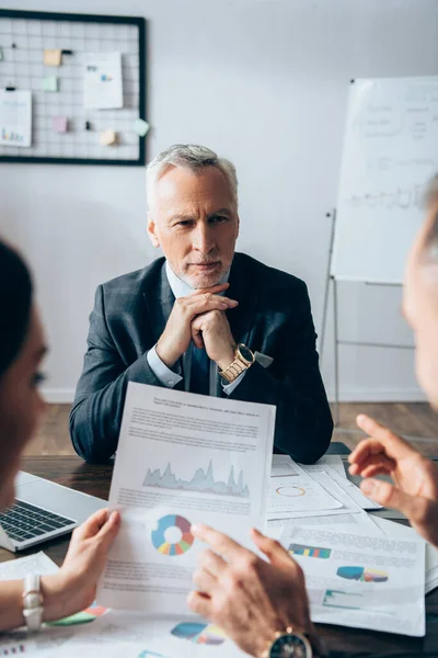 Mature Investor Looking Business Partners Documents Blurred Foreground — Stock Photo, Image