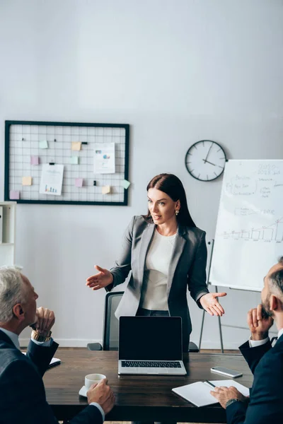 Businesswoman Pointing Hands Laptop Blank Screen Colleagues Coffee Notebook Blurred — Stock Photo, Image