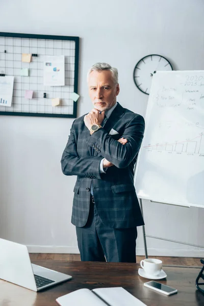 Confident Businessman Looking Camera Gadgets Notebook Blurred Foreground — Stock Photo, Image