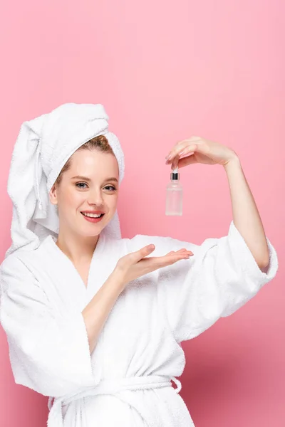 Smiling Young Woman Bathrobe Towel Head Holding Serum Isolated Pink — Stock Photo, Image