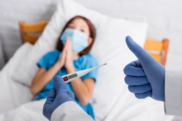 Doctor Holding Thermometer Showing Thumb Child Medical Mask Lying Bed — Foto de Stock