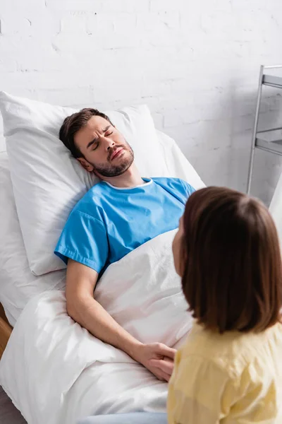 Girl Holding Hand Sick Father Frowning While Lying Hospital Bed — Stock Photo, Image