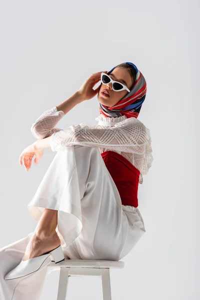 Young Woman Headscarf Stylish Sunglasses Sitting Stool While Posing Isolated — Stock Photo, Image