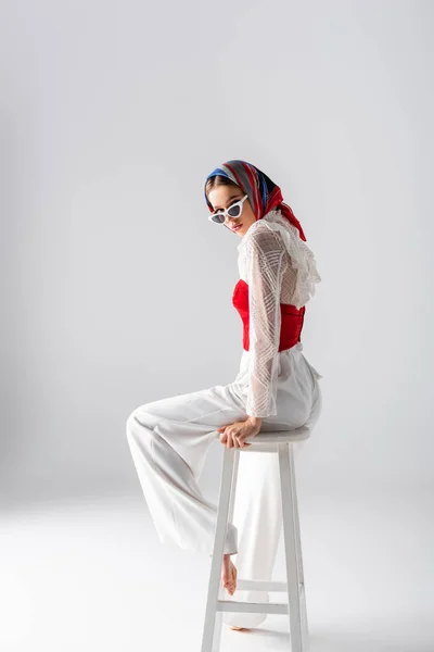 Full Length Stylish Woman Headscarf Sunglasses Sitting Stool While Looking — Stock Photo, Image