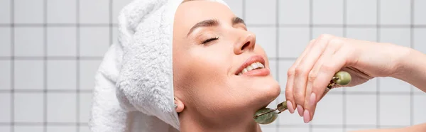 Happy Woman Closed Eyes Towel Head Using Jade Roller Bathroom — Stock Photo, Image