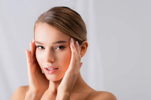 Young Woman Bare Shoulders Looking Camera Touching Face White — Stock Photo, Image