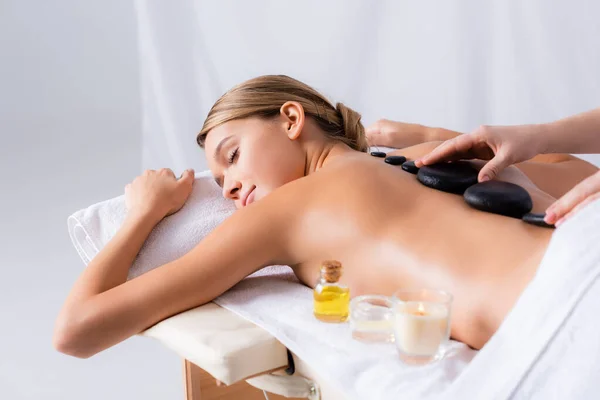 Masseur Doing Hot Stone Massage Young Woman Closed Eyes Spa — Stock Photo, Image