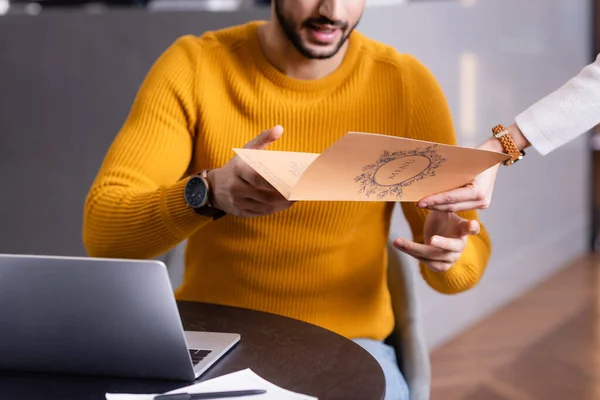 Cropped View Arabian Freelancer Taking Menu Card Waitress Restaurant Blurred — Stock Photo, Image