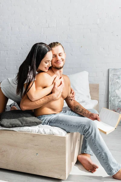 Woman Shirt Touching Muscular Boyfriend Book Bed — Stock Photo, Image