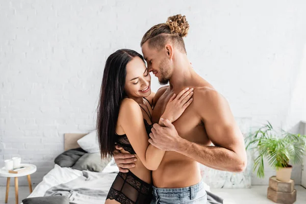 Sexy Man Embracing Smiling Woman Lingerie Bedroom — Stock Photo, Image