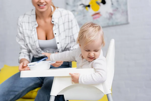 Frowning Toddler Turning Away Bowl Puree Mother Blurred Background — Stock Photo, Image