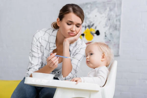Tired Woman Feeding Little Son Sitting Kids Chair — Stock Photo, Image