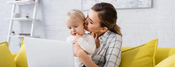 Young Freelancer Kissing Little Son While Sitting Laptop Banner — Stock Photo, Image