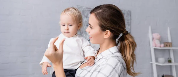 Smiling Mother Showing Small Amount Gesture While Holding Little Son — Stock Photo, Image