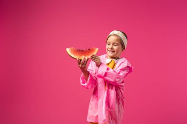 happy girl in raincoat holding watermelon on crimson clipart