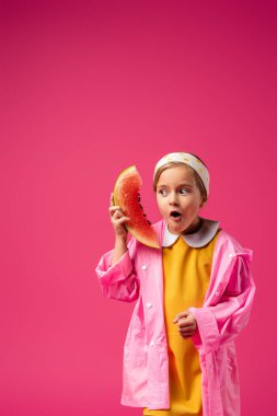 surprised girl in raincoat holding watermelon on crimson clipart