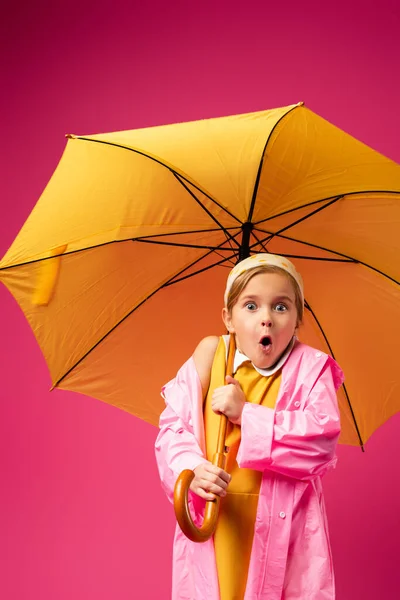 Shocked Girl Raincoat Standing Umbrella Isolated Crimson — Stock Photo, Image