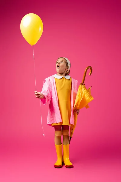 Full Length Amazed Girl Raincoat Rubber Boots Holding Balloon Yellow — Stock Photo, Image