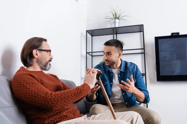 Excited Hispanic Man Gesturing While Talking Dad Living Room — Stock Photo, Image