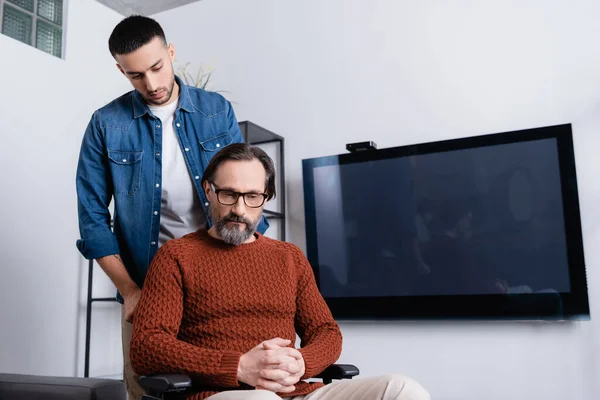 Young Hispanic Man Upset Disabled Father Wheelchair — Stock Photo, Image