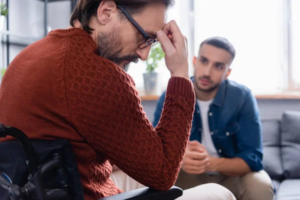 Young Hispanic Man Looking Depressed Handicapped Father Holding Hand Forehead — Stock Photo, Image