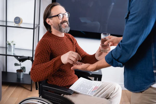 Happy Disabled Man Taking Medicine Glass Water Son — Stock Photo, Image