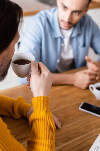 Man Drinking Coffee Young Hispanic Son Blurred Background Kitchen — Stock Photo, Image