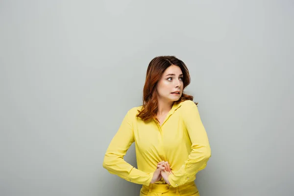 Frightened Woman Looking Away While Standing Clenched Hands Grey — Stock Photo, Image