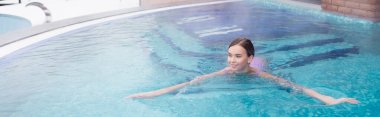 happy young woman swimming in hot spring pool, banner clipart