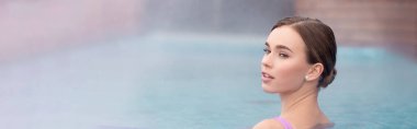 young woman looking away and taking bath in outdoor hot spring pool, banner clipart