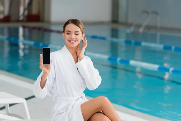 Cheerful Woman White Bathrobe Holding Smartphone Blank Screen Spa Center — Stock Photo, Image