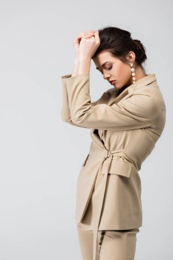 İnci küpeli zarif bir kadın. Gri renkli gözleriyle poz veriyor.