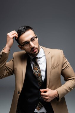 Tarz sahibi müslüman adam başını kaldırıp griye bakıyor.