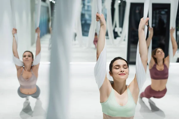 Group Young Sportswomen Stretching Aerial Yoga Straps Blurred Foreground — Stock Photo, Image