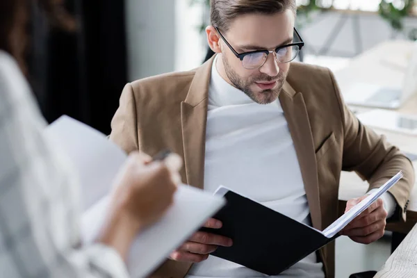 Businessman Looking Documents Colleague Notebook Blurred Foreground — Stock Photo, Image